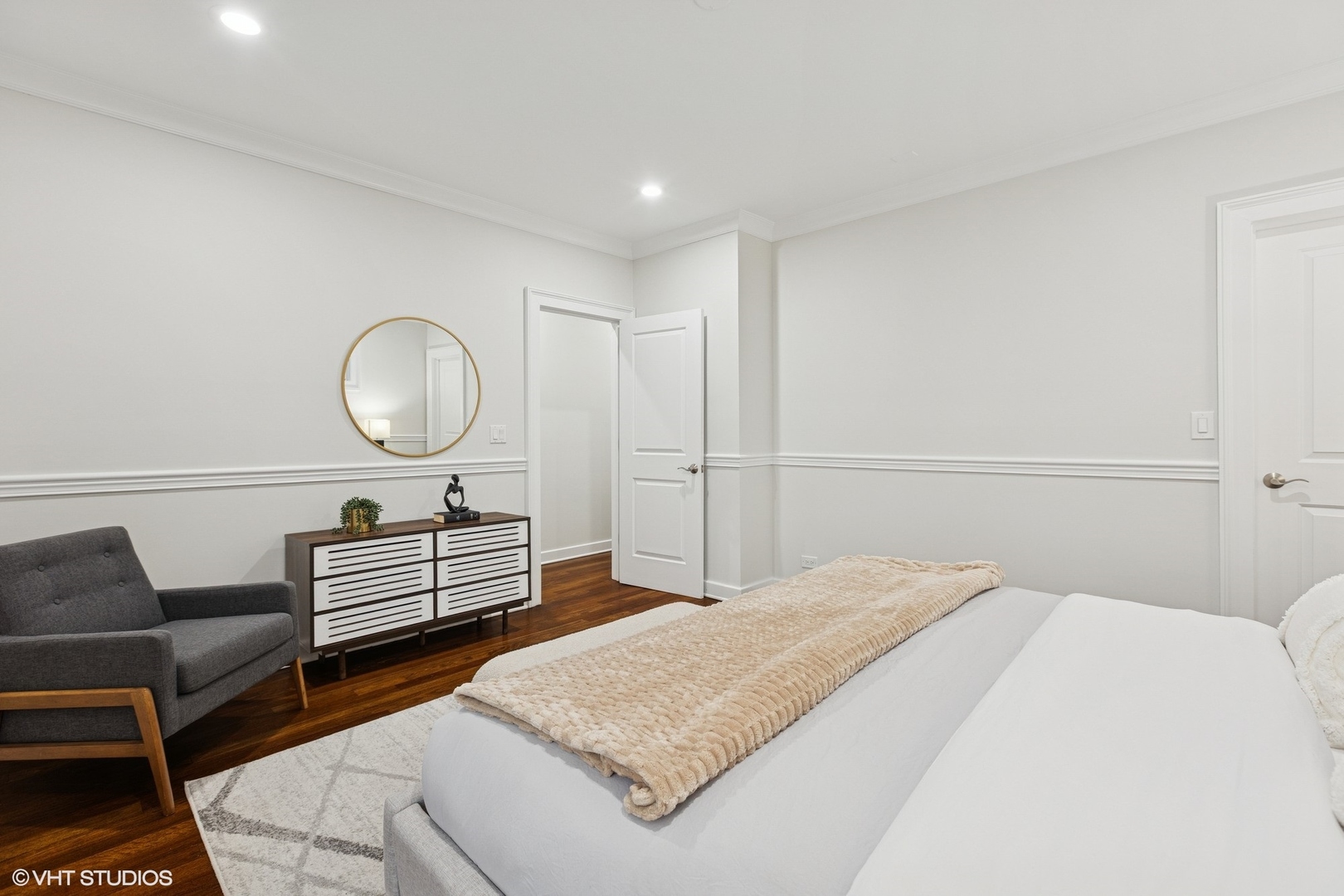 1035 West Monroe Street, Unit 1 Chicago, IL 60607 - Photo 22 of 27 a bedroom with a bed and dresser with wooden floor