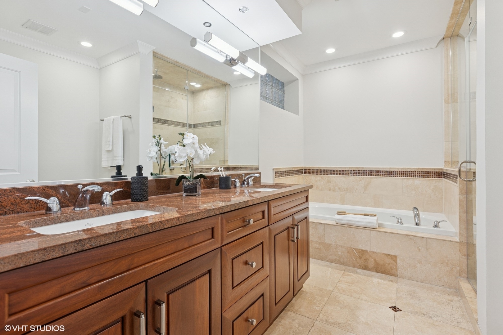 1035 West Monroe Street, Unit 1 Chicago, IL 60607 - Photo 23 of 27 a spacious bathroom with a granite countertop sink mirror and bathtub