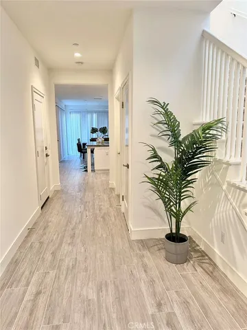 a view of living room filled with furniture and potted plant