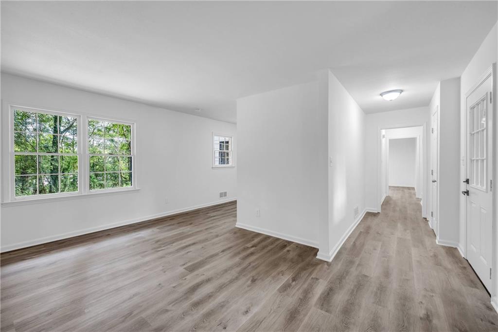 1586 Kings Road Marietta, GA 30062 - Photo 11 of 66 an empty room with wooden floor and windows