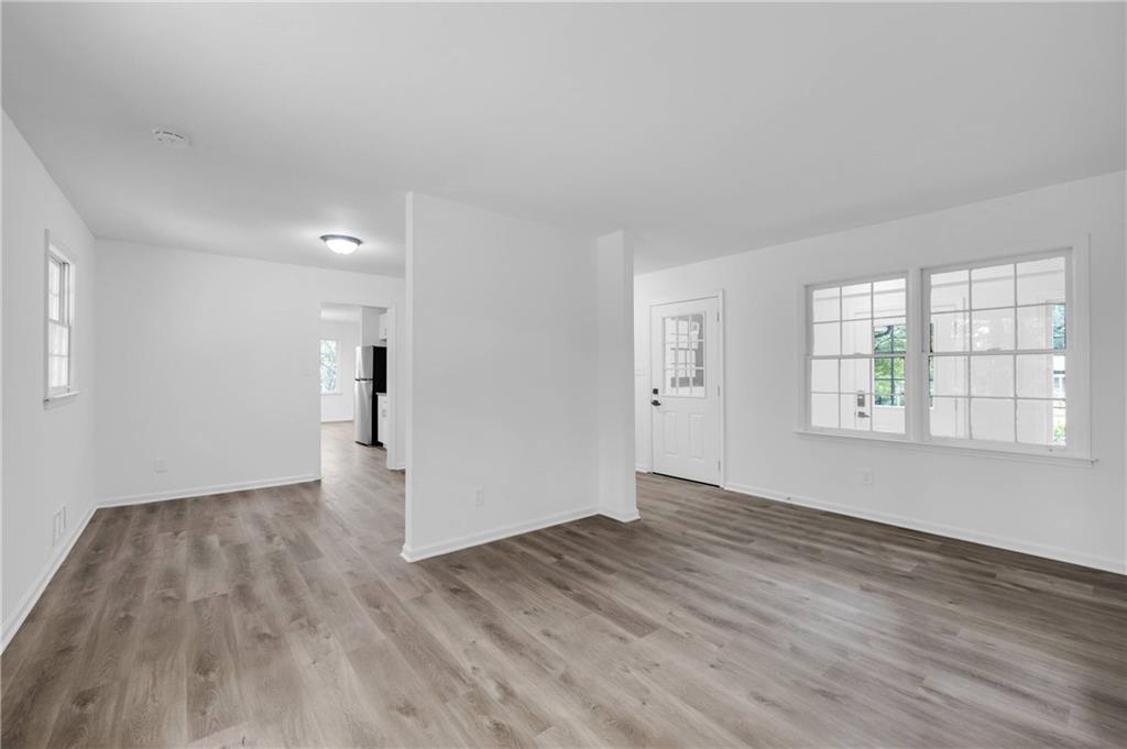 1586 Kings Road Marietta, GA 30062 - Photo 12 of 66 an empty room with wooden floor and windows