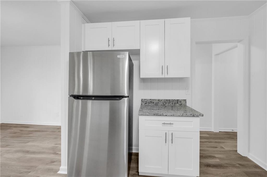 1586 Kings Road Marietta, GA 30062 - Photo 19 of 66 a kitchen with white cabinets and refrigerator