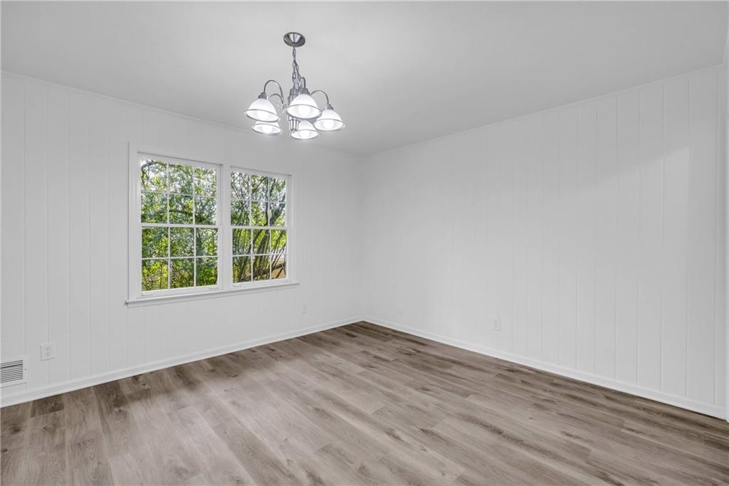 1586 Kings Road Marietta, GA 30062 - Photo 22 of 66 an empty room with wooden floor chandelier and window