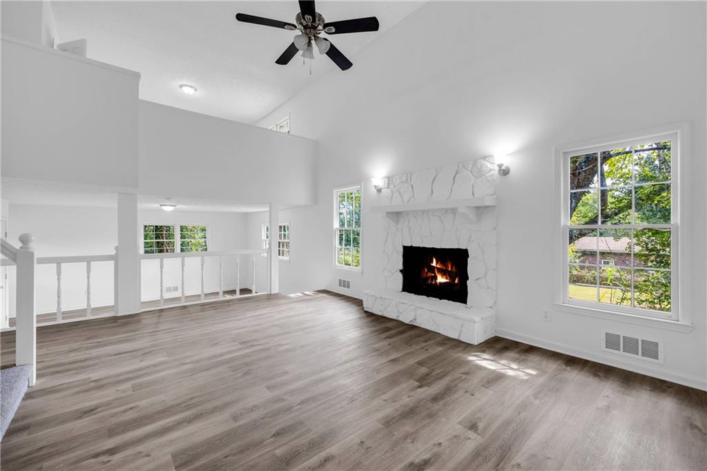 1586 Kings Road Marietta, GA 30062 - Photo 26 of 66 a view of an empty room with wooden floor fireplace and a window
