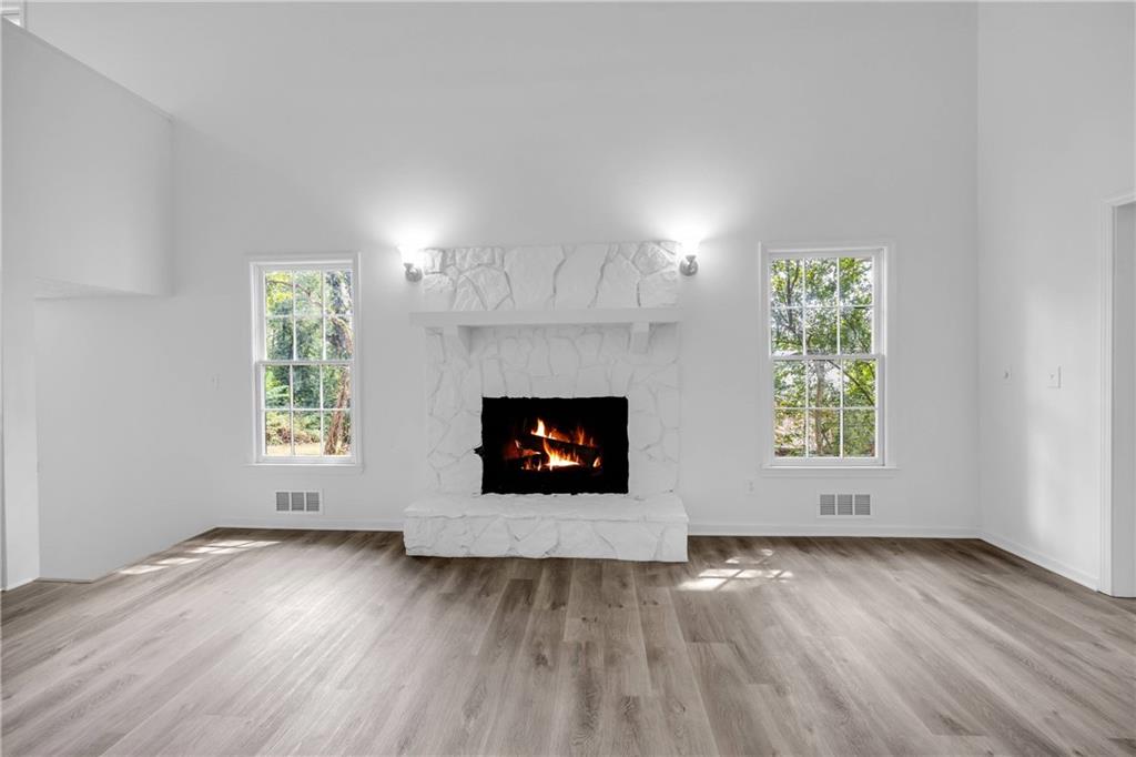 1586 Kings Road Marietta, GA 30062 - Photo 27 of 66 an empty room with wooden floor a fireplace and windows