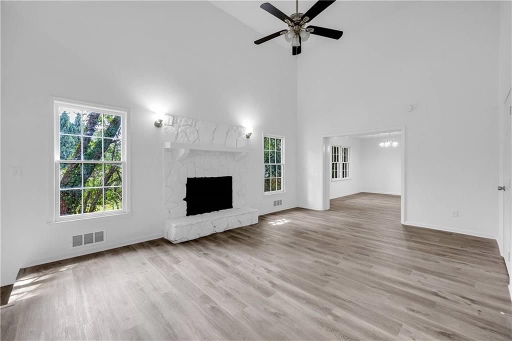 1586 Kings Road Marietta, GA 30062 - Photo 28 of 66 an empty room with wooden floor a fireplace and windows
