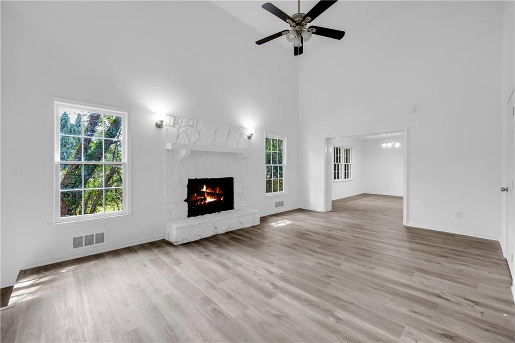 1586 Kings Road Marietta, GA 30062 - Photo 29 of 66 an empty room with wooden floor a fireplace and windows