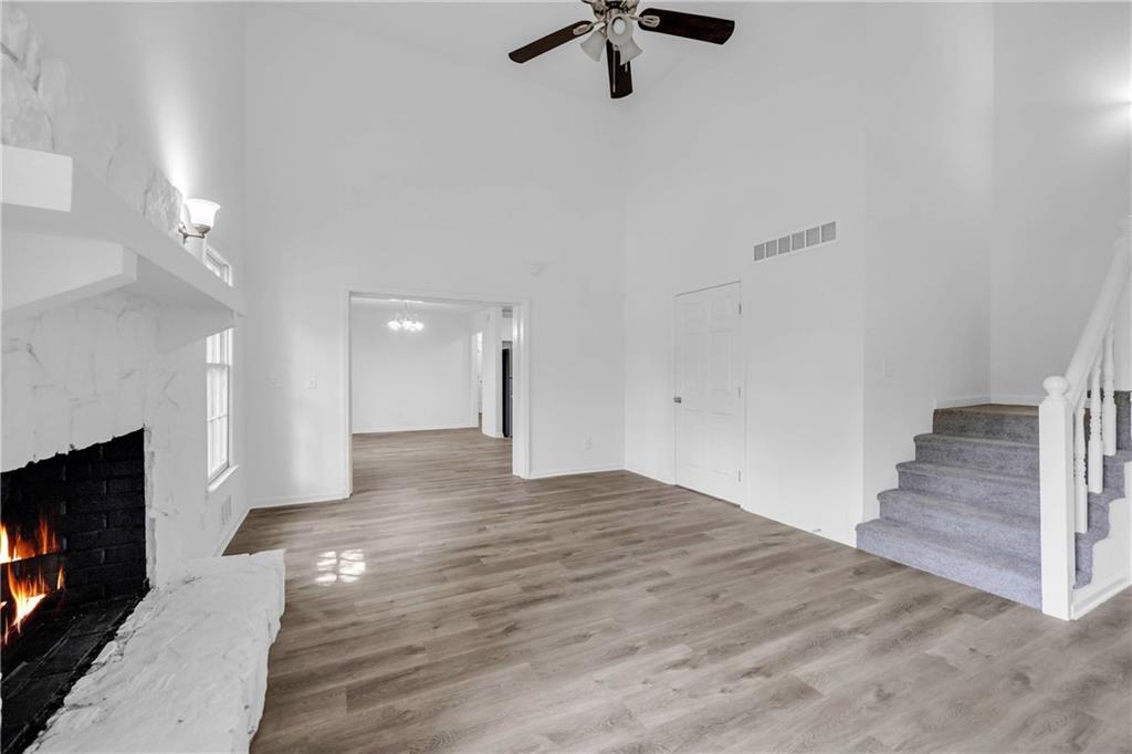 1586 Kings Road Marietta, GA 30062 - Photo 30 of 66 a view of an empty room with wooden floor fireplace and a window
