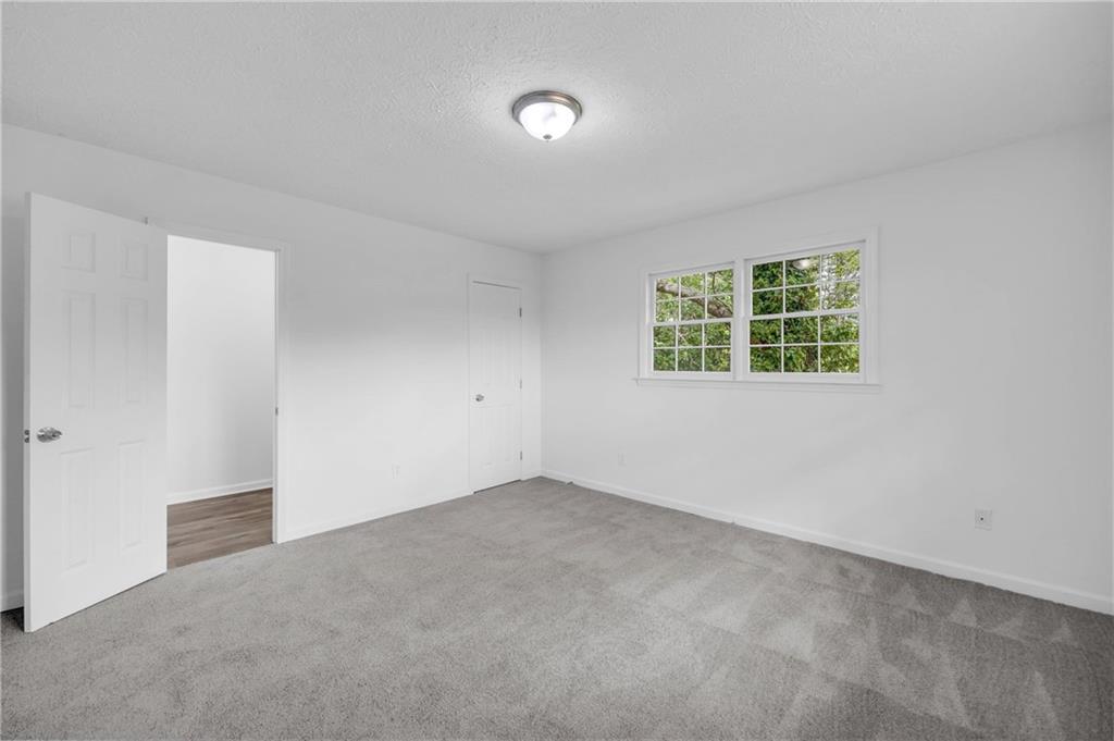 1586 Kings Road Marietta, GA 30062 - Photo 33 of 66 an empty room with windows
