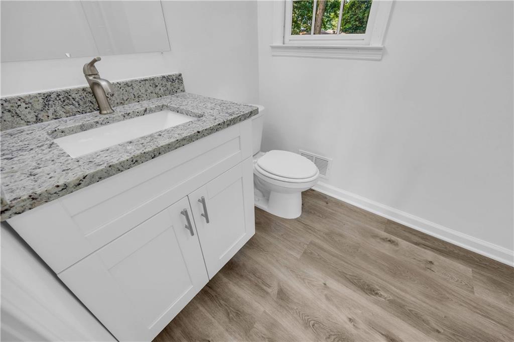 1586 Kings Road Marietta, GA 30062 - Photo 37 of 66 a bathroom with a granite countertop sink toilet and a vanity
