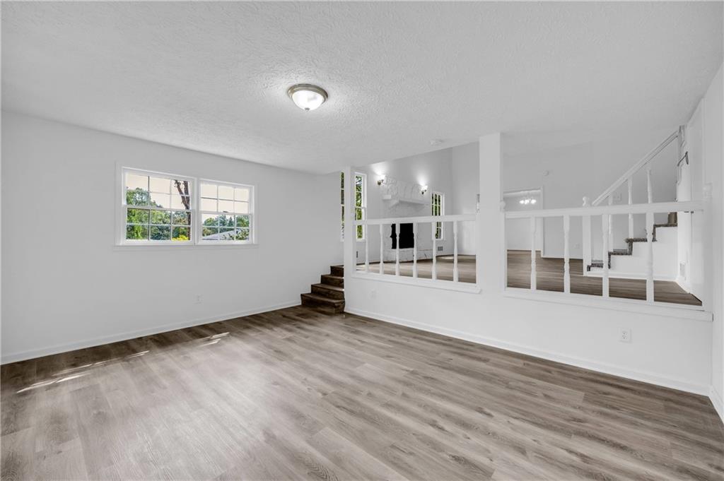 1586 Kings Road Marietta, GA 30062 - Photo 41 of 66 a view of an empty room with wooden floor and a window