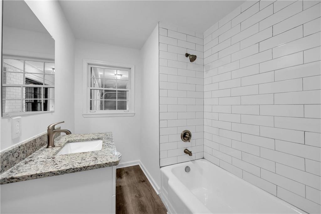 1586 Kings Road Marietta, GA 30062 - Photo 47 of 66 a bathroom with a granite countertop sink mirror and bathtub