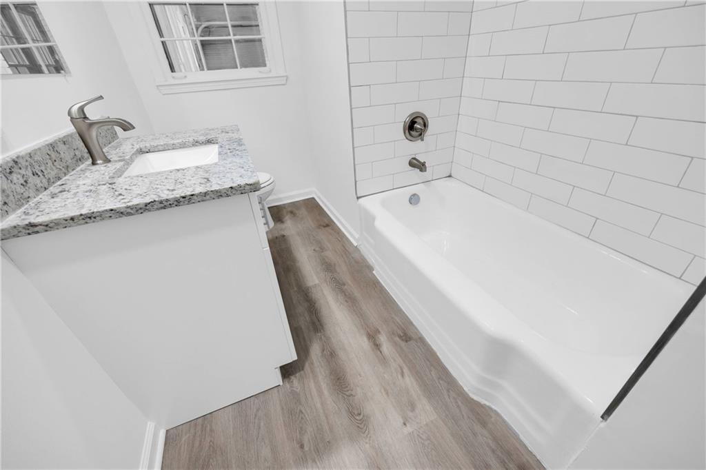 1586 Kings Road Marietta, GA 30062 - Photo 48 of 66 a bathroom with a granite countertop sink toilet and bathtub