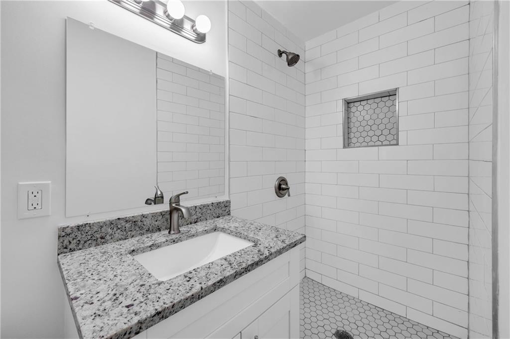 1586 Kings Road Marietta, GA 30062 - Photo 53 of 66 a bathroom with a granite countertop sink and a mirror