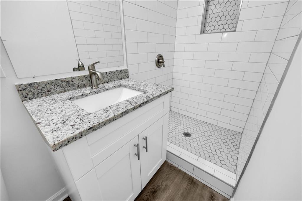 1586 Kings Road Marietta, GA 30062 - Photo 54 of 66 a bathroom with a granite countertop sink and a mirror
