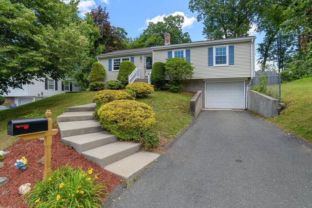 73 Sawmill Road Springfield, MA 01118 - Photo 1 of 30 a front view of a house with garden