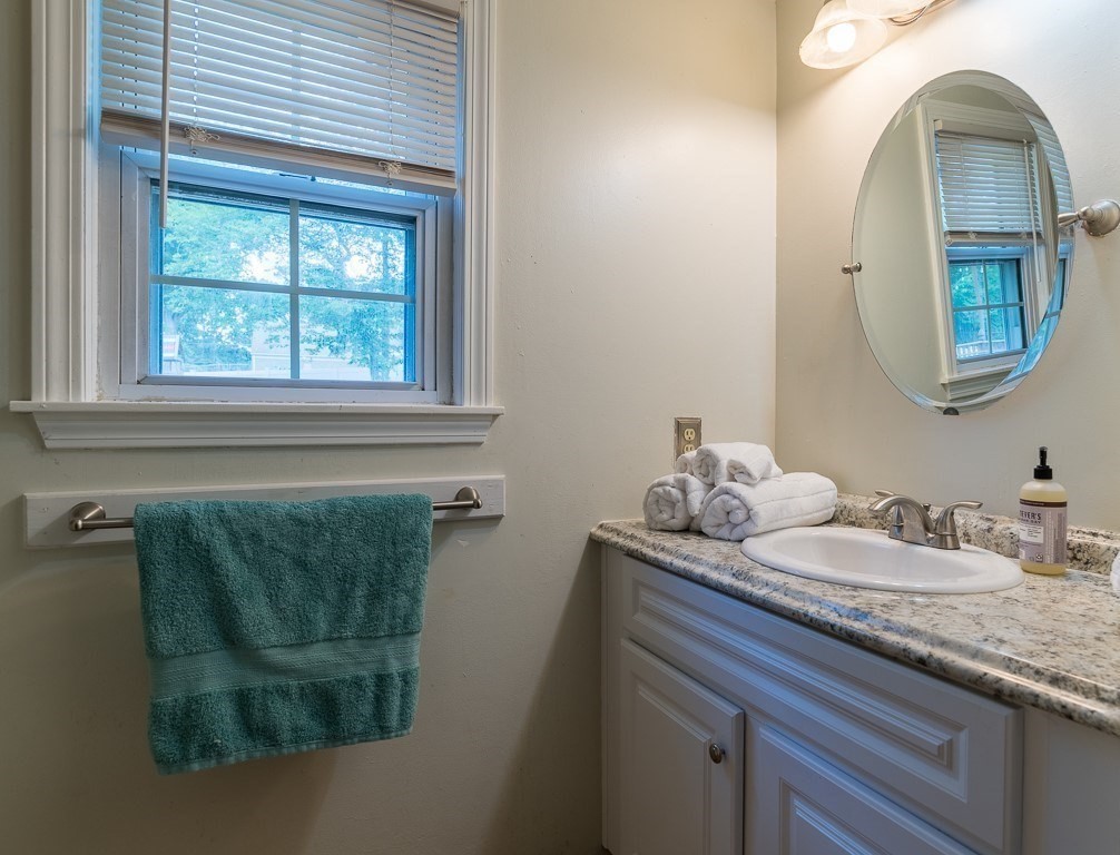 73 Sawmill Road Springfield, MA 01118 - Photo 15 of 30 a bathroom with a granite countertop sink and a mirror
