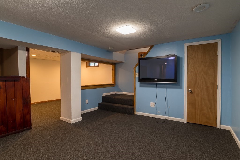 73 Sawmill Road Springfield, MA 01118 - Photo 17 of 30 a living room with furniture and a flat screen tv