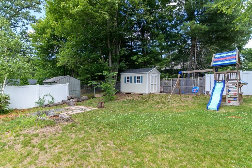 73 Sawmill Road Springfield, MA 01118 - Photo 27 of 30 a backyard of a house with slide and trees