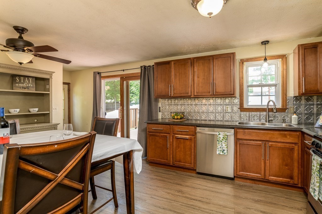 73 Sawmill Road Springfield, MA 01118 - Photo 6 of 30 a kitchen with stainless steel appliances granite countertop a stove a sink dishwasher and a microwave oven on the wooden floor