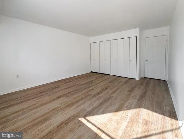 a view of a room with wooden floor