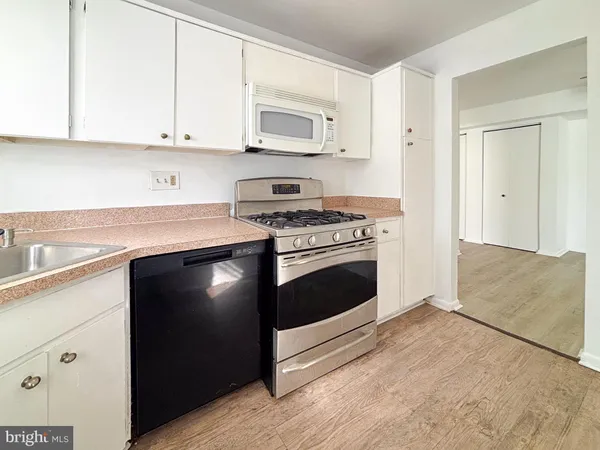 a kitchen with cabinets appliances and a sink