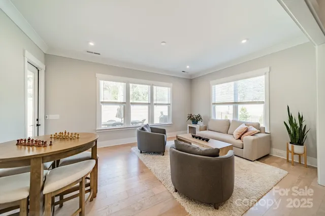 a living room with furniture and floor to ceiling windows