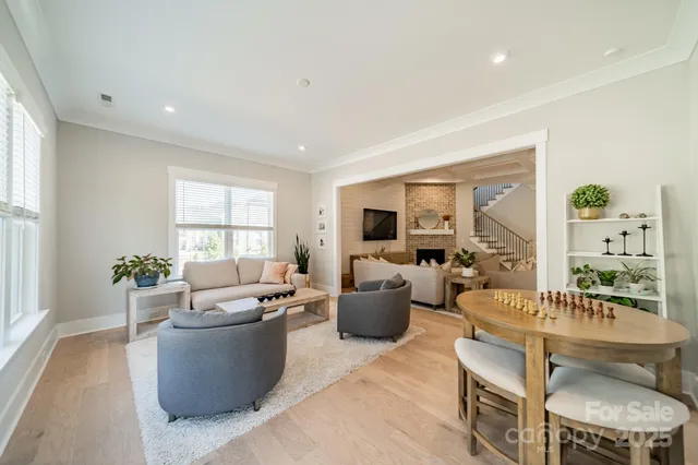 a living room with fireplace furniture and a large window