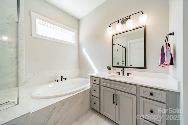 a bathroom with a double vanity sink mirror and