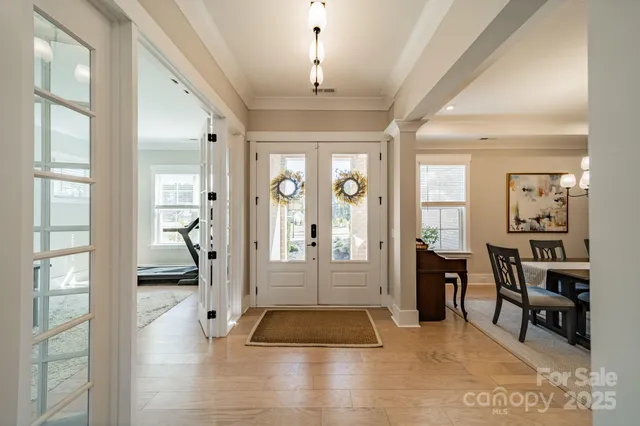a living room with furniture and a chandelier