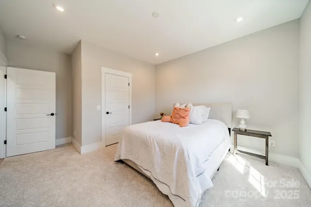 a bedroom with a bed and a lamp