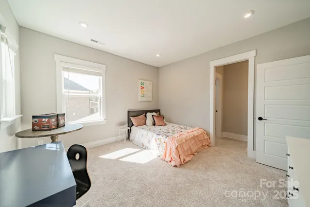 a bedroom with furniture and a window