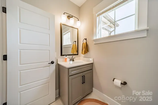 a bathroom with a sink a vanity and a mirror