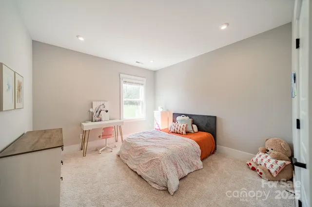 a bedroom with a bed and window