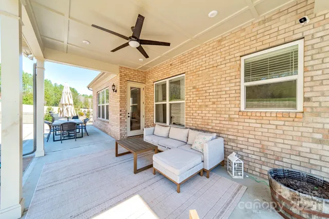 a living room with patio furniture and a window