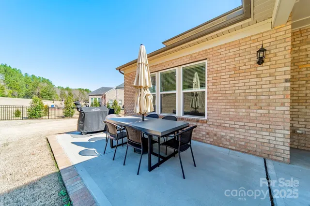 a view of a house with yard and sitting area