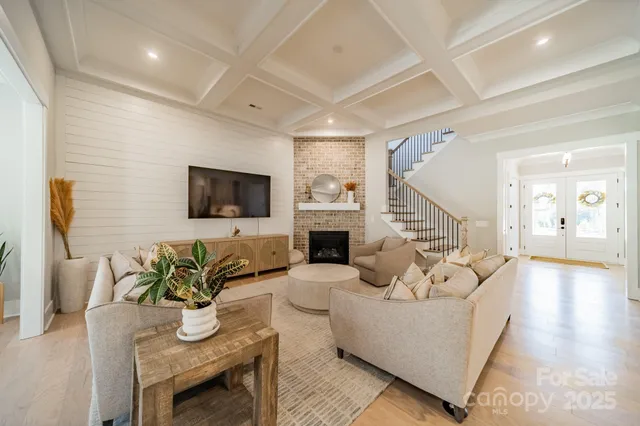 a living room with fireplace furniture and a flat screen tv