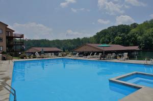 610 Monte Vista Road, Unit 705 Union Hall, VA 24176 - Photo 17 of 74 a view of a large pool with lawn chairs under an umbrella