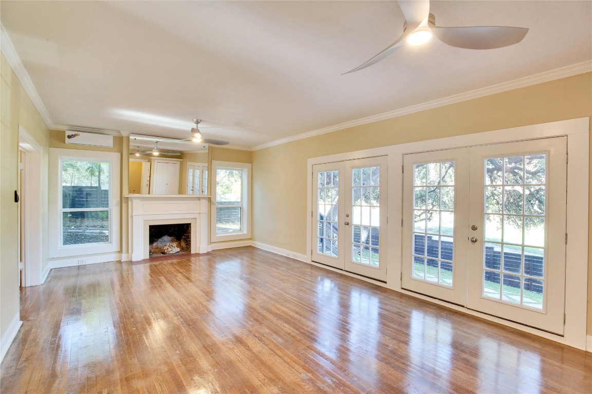 1115 Enfield Road, Unit B Austin, TX 78703 - Photo 13 of 34 a view of an empty room with wooden floor and a window