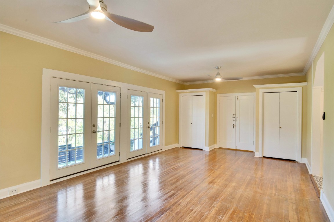 1115 Enfield Road, Unit B Austin, TX 78703 - Photo 15 of 34 a view of an empty room with wooden floor and a window