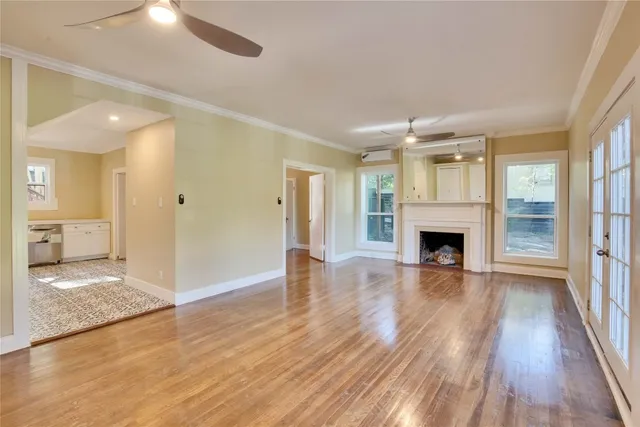 a view of empty room with wooden floor and fireplace