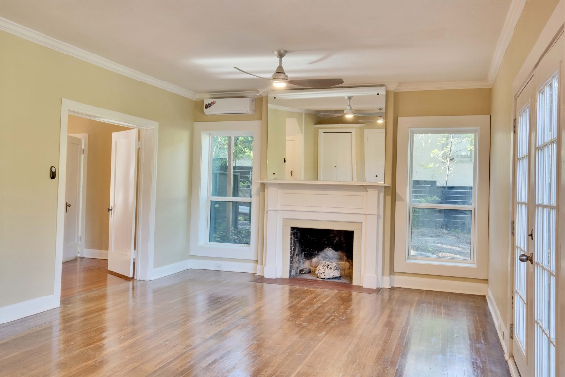 1115 Enfield Road, Unit B Austin, TX 78703 - Photo 19 of 34 a view of an empty room window and wooden floor