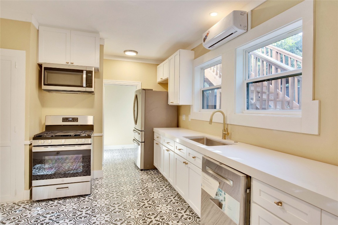 1115 Enfield Road, Unit B Austin, TX 78703 - Photo 22 of 34 a kitchen with a sink stove and microwave