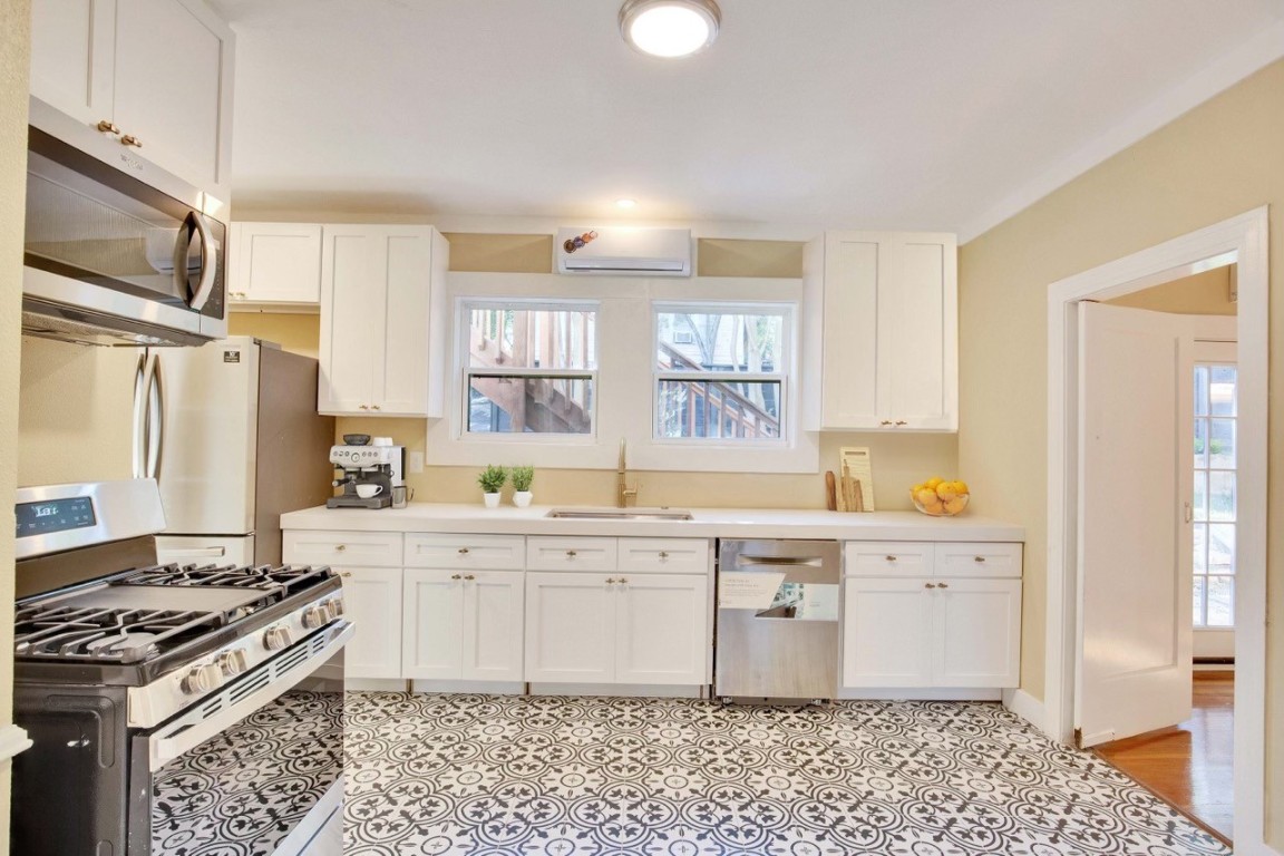 1115 Enfield Road, Unit B Austin, TX 78703 - Photo 23 of 34 a kitchen with a stove a sink and a window