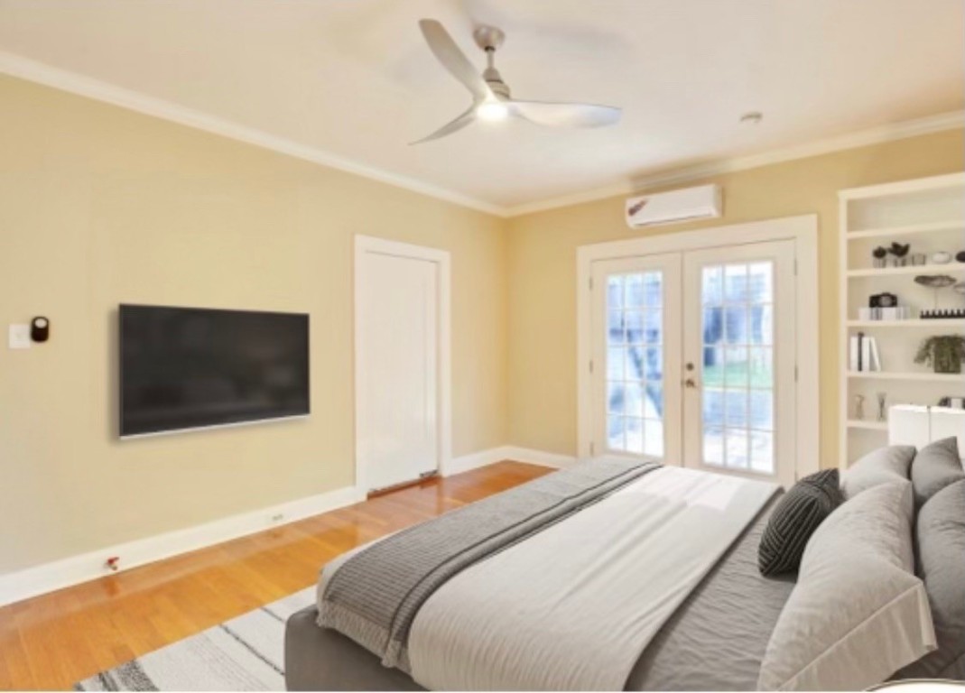 1115 Enfield Road, Unit B Austin, TX 78703 - Photo 24 of 34 a bedroom with a bed and a flat screen tv