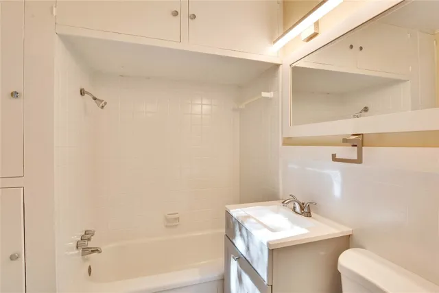 a bathroom with a sink toilet and vanity