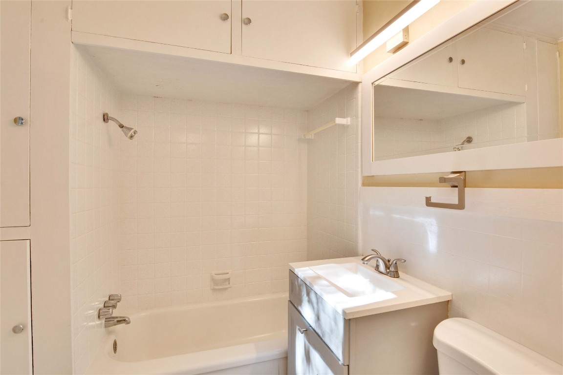 1115 Enfield Road, Unit B Austin, TX 78703 - Photo 28 of 34 a bathroom with a sink toilet and vanity