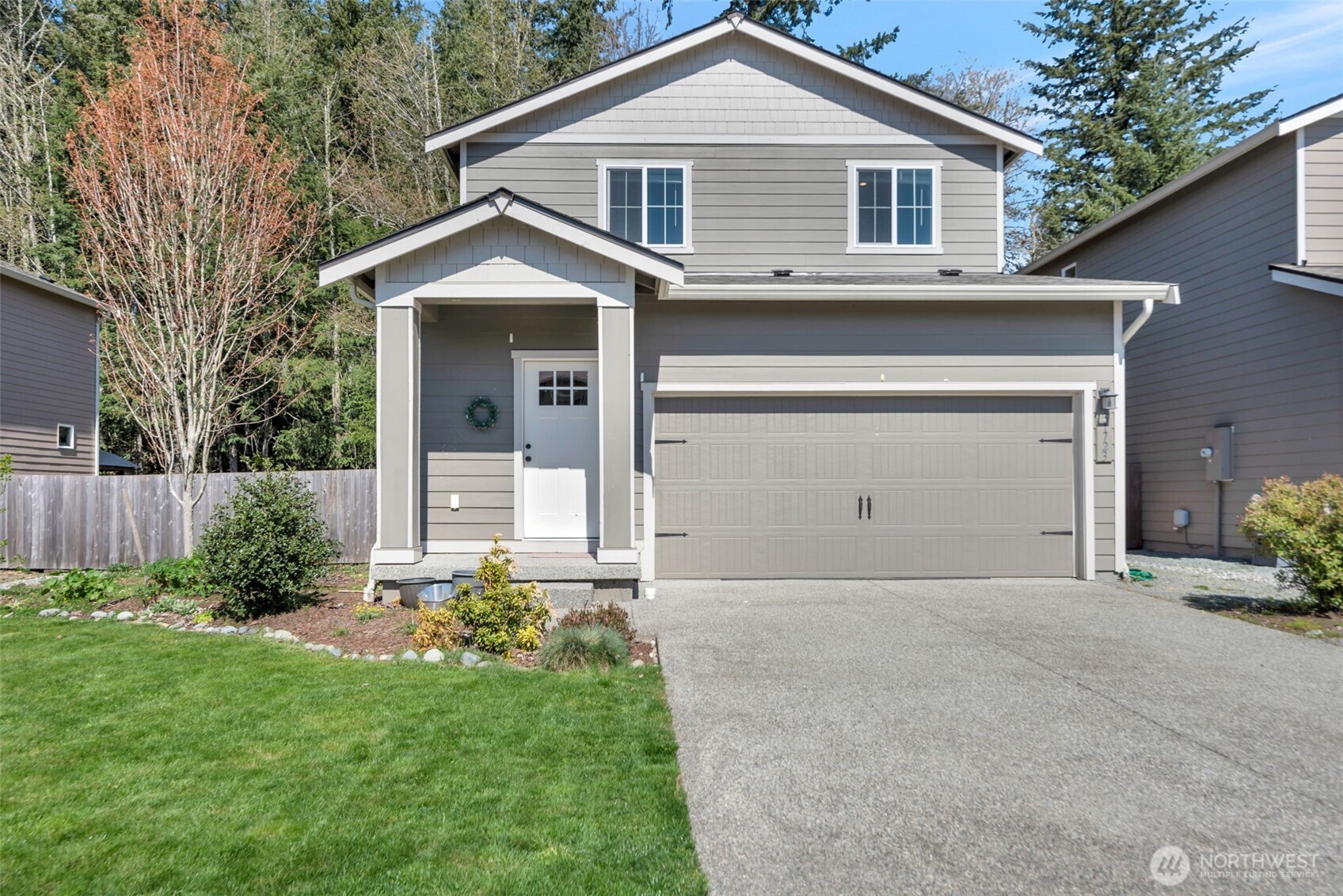 31723 120th Street Southeast Sultan, WA 98294 - Photo 2 of 27 a front view of a house with a yard and garage