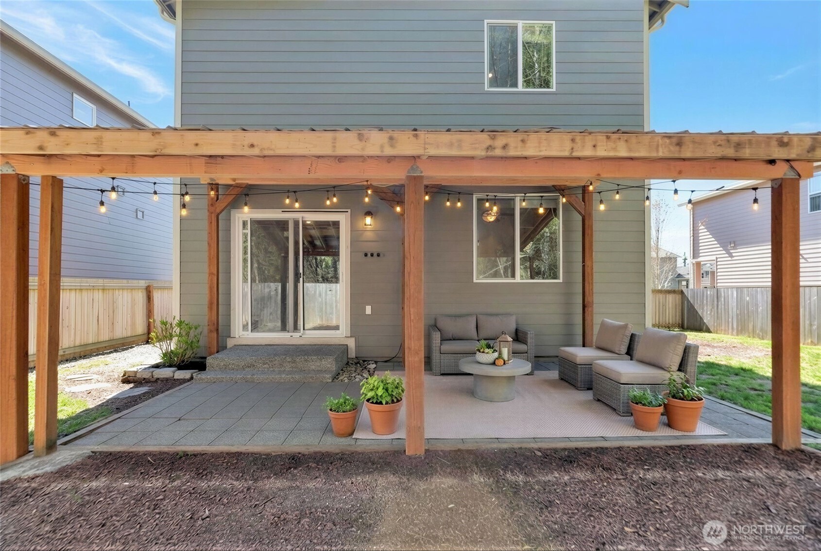 31723 120th Street Southeast Sultan, WA 98294 - Photo 21 of 27 a view of a patio with a table and chairs and potted plants