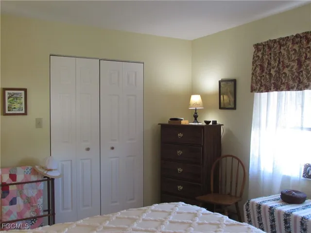 a bedroom with a bed and a table